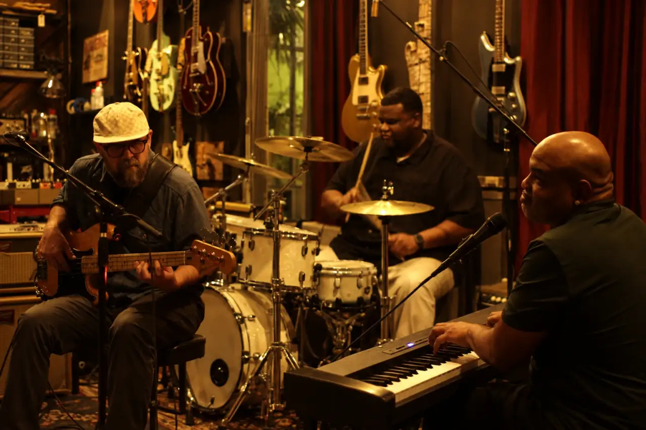 BB Wright on bass, Walter Dean IV on drums and Stacey Wade at the keys, playing live in a guitar shop